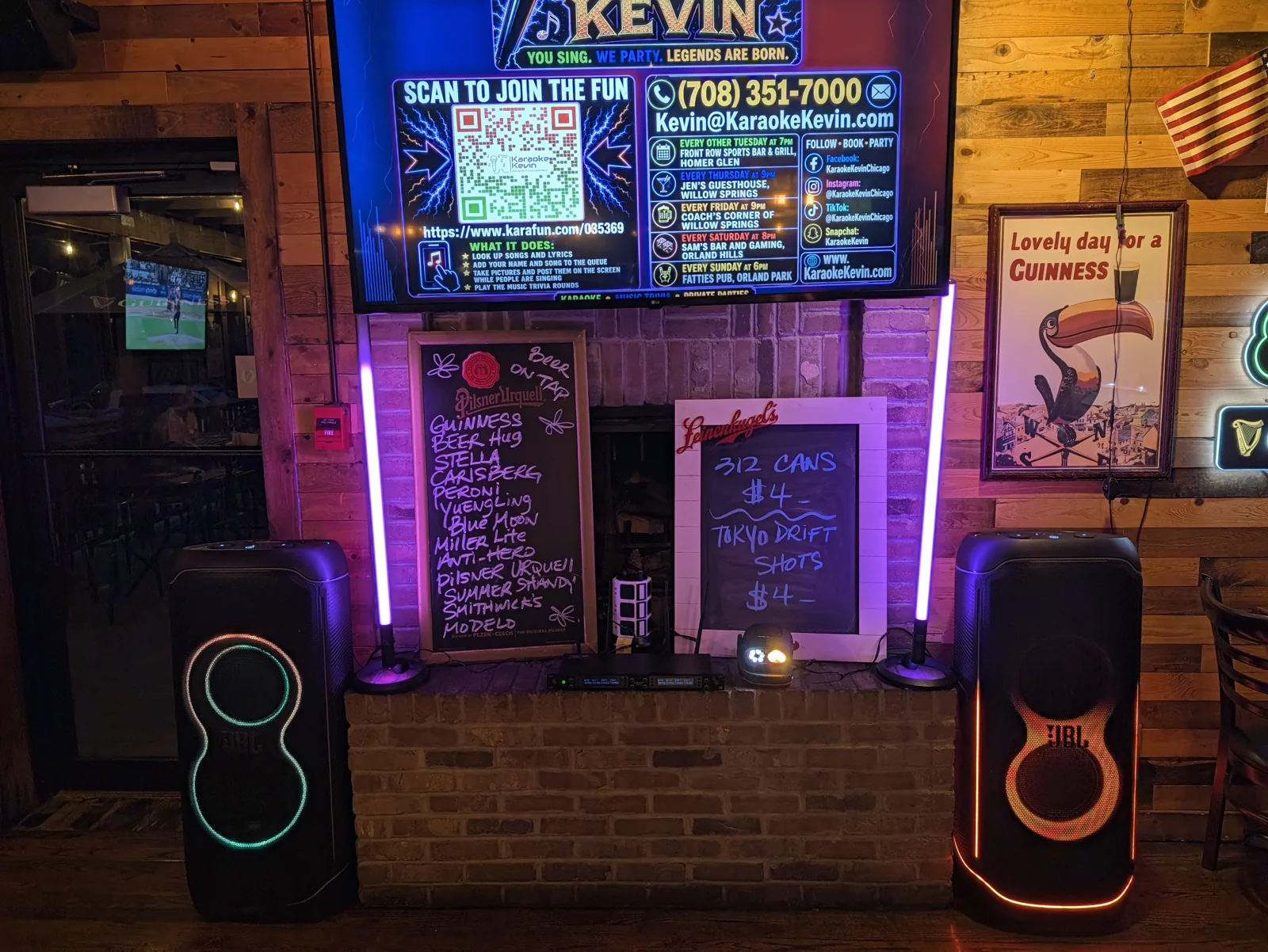 Two illuminated JBL speakers, purple light sticks and a party light at a Karaoke Kevin show