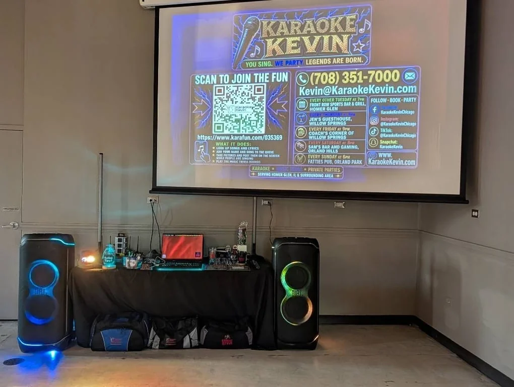 Karaoke Kevin branding projected above a host station flanked by two JBL speakers